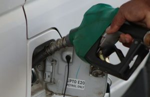 The Impact of Increased Fuel Prices in Nigeria A black man’s hand holding a fuel pump at a car fueling station, representing the impact of increased fuel prices in Nigeria.