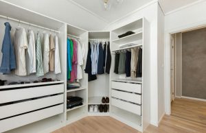 How To Create A Capsule Wardrobe On A Budget Minimalist wardrobe with neutral clothing and shoes organized neatly, perfect for learning how to create a capsule wardrobe on a budget.