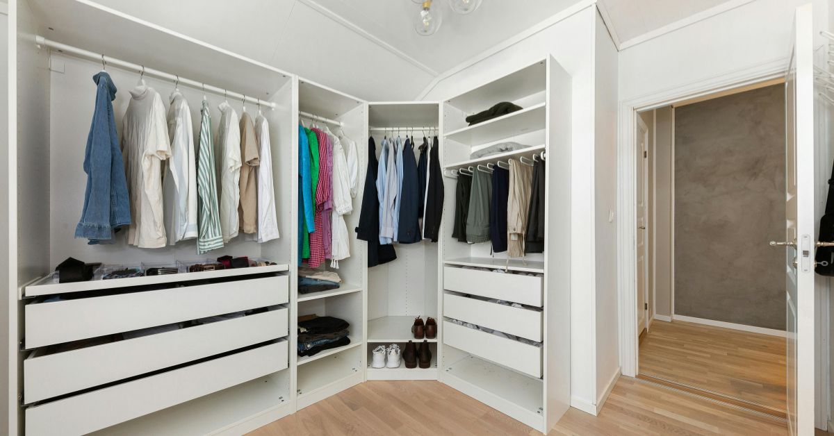 Minimalist wardrobe with neutral clothing and shoes organized neatly, perfect for learning how to create a capsule wardrobe on a budget.