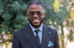 How To Build Self-Confidence – Building Confidence 101 Confident black man in suit smiling outdoors, representing how to build self-confidence through style and positive mindset