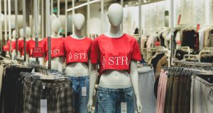 Best Ethical And Sustainable Fashion Brands You Should Know in 2025 A modern fashion store displaying mannequins dressed in eco-friendly outfits and clothing racks, showcasing the best ethical and sustainable fashion brands.