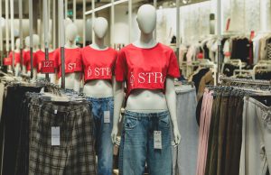Best Ethical And Sustainable Fashion Brands You Should Know in 2025 A modern fashion store displaying mannequins dressed in eco-friendly outfits and clothing racks, showcasing the best ethical and sustainable fashion brands.