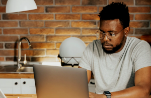 25 High-Paying Remote Jobs You Can Land in 2025 (No Coding Required) a man working from home on his laptop, demonstrating 25 high-paying remote jobs 2025