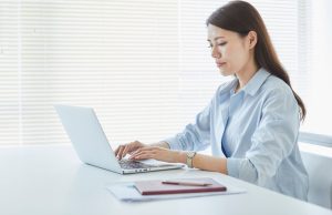 How to Write a Professional Follow-Up Email After a Business Meeting A professional writing a follow-up email after a business meeting to ensure clear communication and next steps.