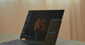 How to Know Fake vs Original Tech Gadgets Before You Buy Online Laptop and phone on wooden stand on grey table – how to know fake vs original tech gadgets before you buy online
