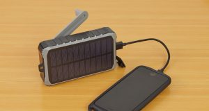 How to Make Your Oraimo Power Bank Last Longer (Real Tips That Work) Power bank charging phone on wooden surface – how to make your Oraimo power bank last longer.