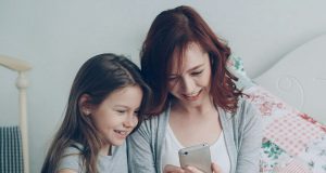 How to Set Up Parental Controls on Android Phones for Kids Parent and child using a phone together, learning how to set up parental controls on Android phones for kids