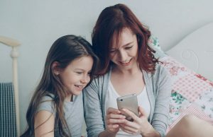 How to Set Up Parental Controls on Android Phones for Kids Parent and child using a phone together, learning how to set up parental controls on Android phones for kids