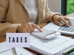Nigerian Government to Enforce Strict Tax Compliance in 2026: What You Must Do Now to Avoid Penalties Close-up of hands reviewing tax documents with a calculator and pen, representing 2026 tax compliance in Nigeria