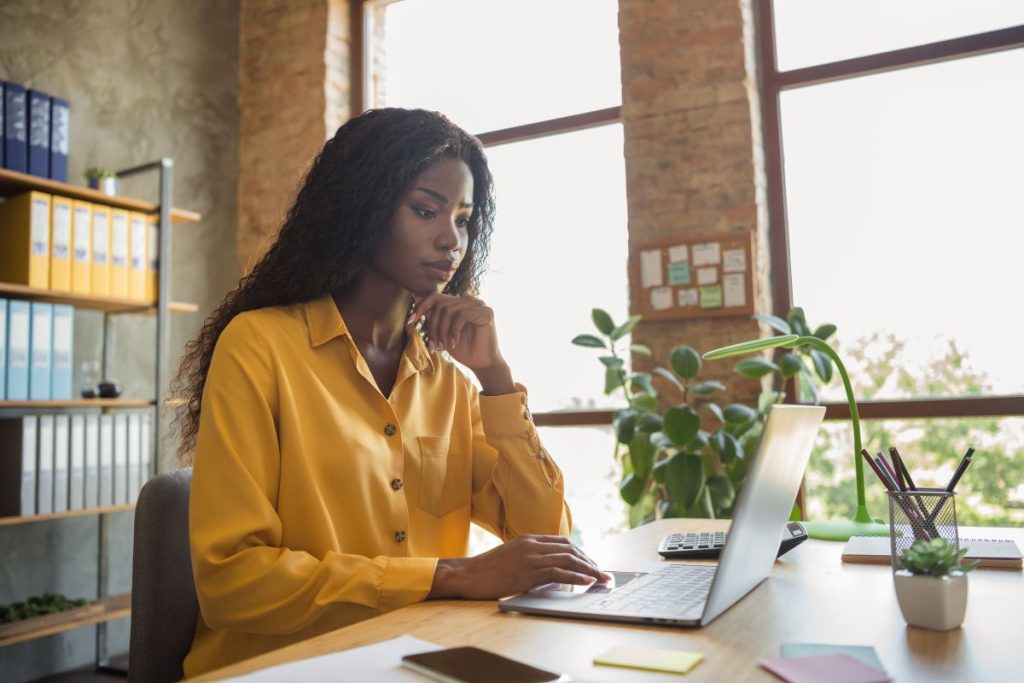 Person working on a laptop at a clean workspace, illustrating how to position yourself for international remote jobs.