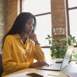Person working on a laptop at a clean workspace, illustrating how to position yourself for international remote jobs.