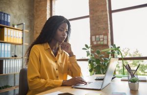 How to Position Yourself for International Remote Jobs Person working on a laptop at a clean workspace, illustrating how to position yourself for international remote jobs.