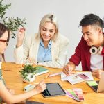 Three entrepreneurs brainstorming business ideas while learning how to turn your passion into a profitable side hustle.