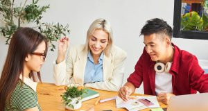 How To Turn Your Passion Into a Profitable Side Hustle Three entrepreneurs brainstorming business ideas while learning how to turn your passion into a profitable side hustle.